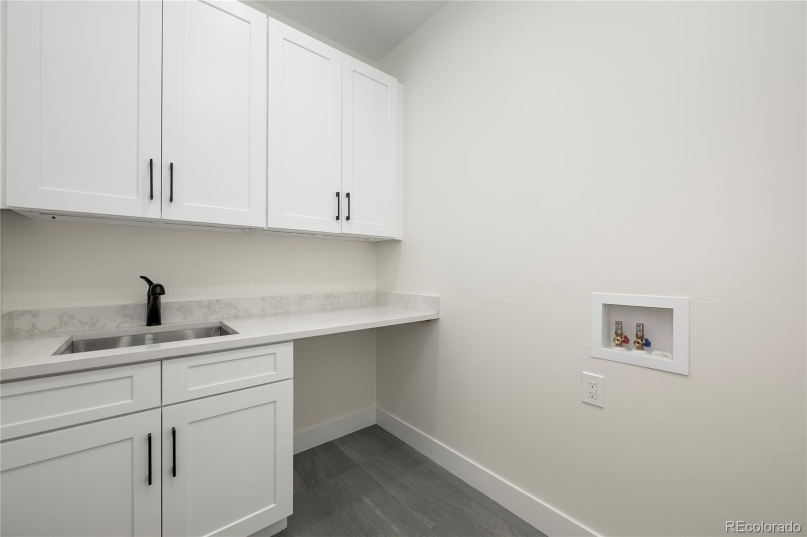 622 Upper Ranch View Drive Granby, CO 80446 - Photo 16 of 50 a kitchen with white cabinets and a sink