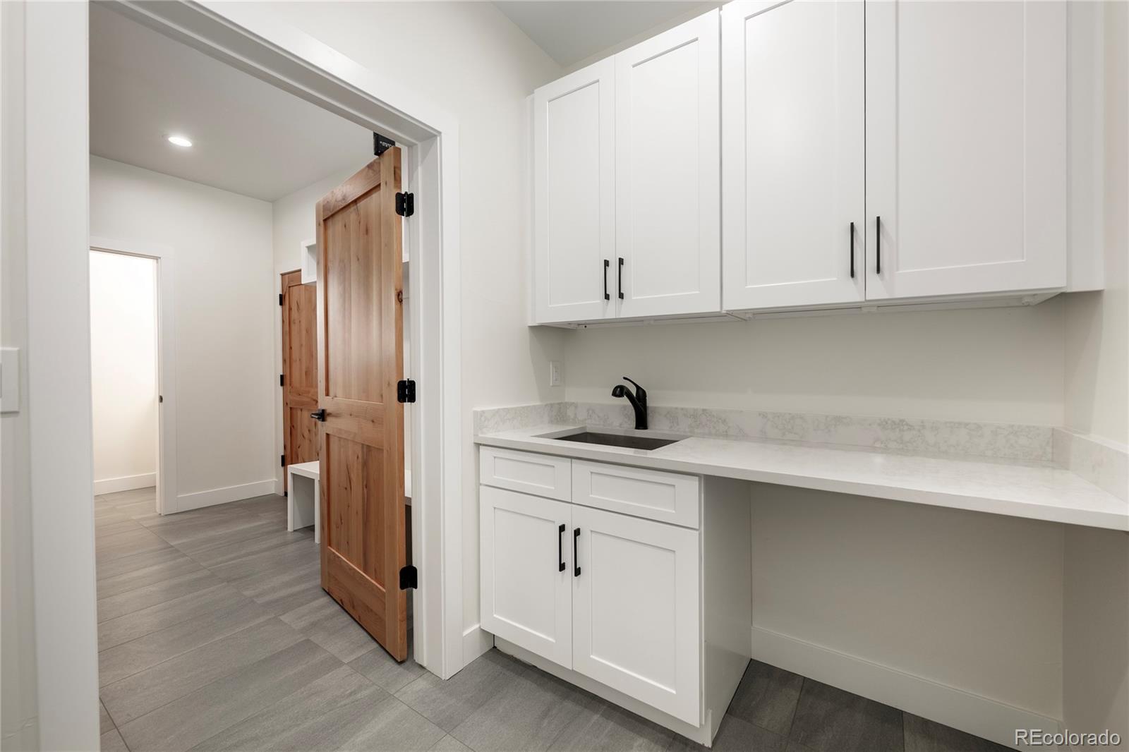 622 Upper Ranch View Drive Granby, CO 80446 - Photo 17 of 50 a view of cabinets a sink and a refrigerator in a room