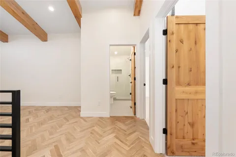 a bathroom with a double vanity sink and mirror with bathtub
