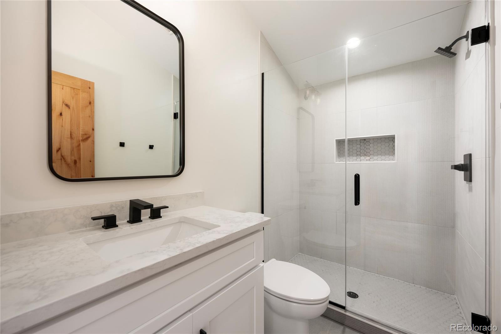 622 Upper Ranch View Drive Granby, CO 80446 - Photo 22 of 50 a bathroom with a sink a toilet and shower