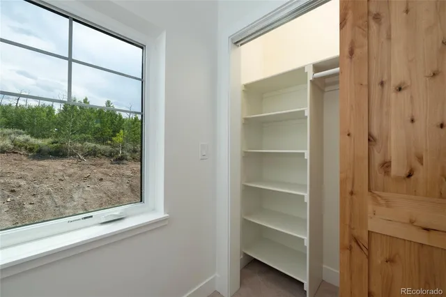 an empty room with closet area