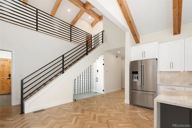 a view of a kitchen with refrigerator and stairs