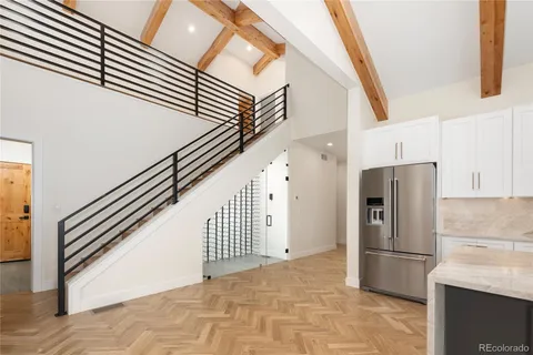 a kitchen with granite countertop a refrigerator and a stove