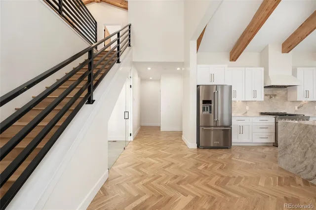a kitchen with granite countertop a refrigerator and a stove