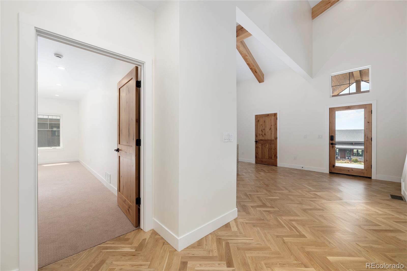 622 Upper Ranch View Drive Granby, CO 80446 - Photo 10 of 50 a view of a hallway with wooden floor and closet
