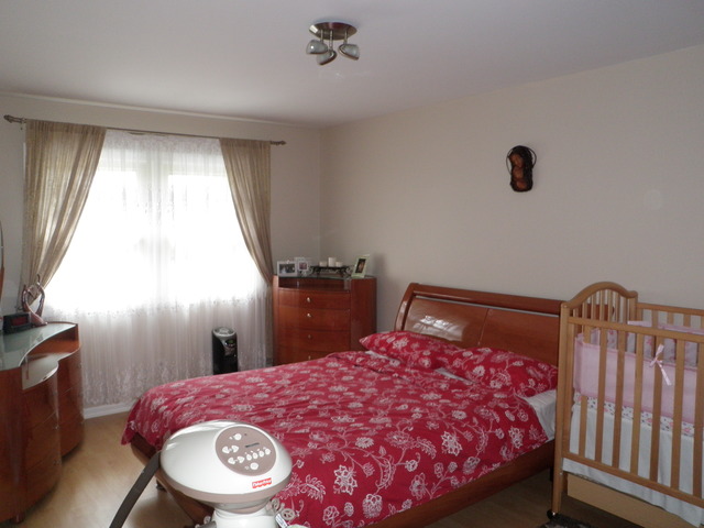 237 Walnut Street, Unit J Elmhurst, IL 60126 - Photo 7 of 8 a bedroom with a bed and a flat tv screen on the dresser