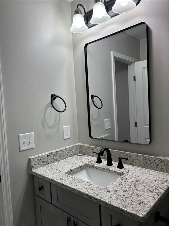 2485 Ortega Way Chamblee, GA 30341 - Photo 11 of 27 a bathroom with a granite countertop sink and a mirror