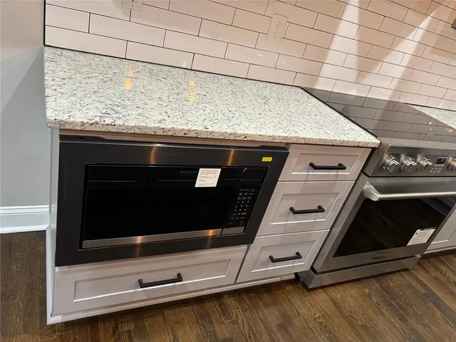 a stove top oven sitting inside of a kitchen