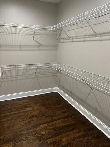 a view of a room with wooden floor