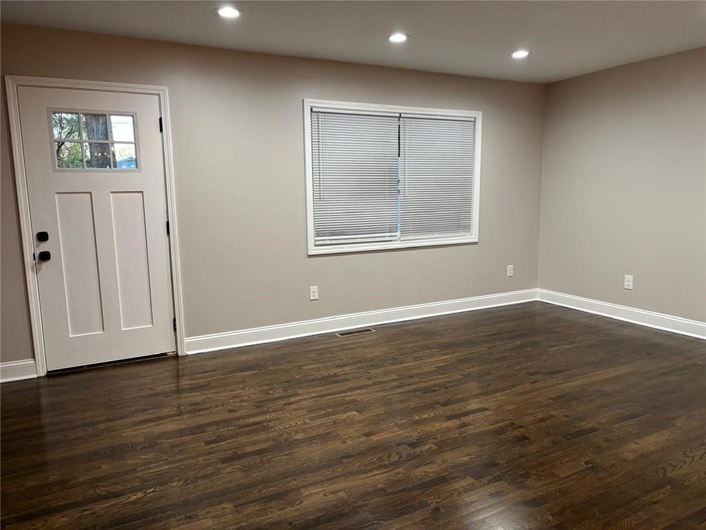 2485 Ortega Way Chamblee, GA 30341 - Photo 2 of 27 an empty room with wooden floor and windows