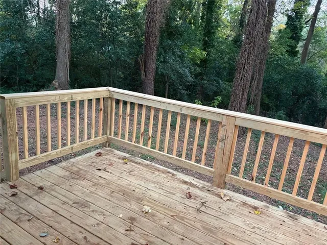 a view of a patio with table and chairs and wooden fence