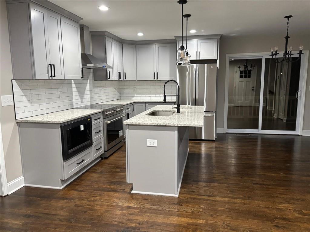 2485 Ortega Way Chamblee, GA 30341 - Photo 6 of 27 a kitchen with stainless steel appliances granite countertop a sink a stove and a refrigerator