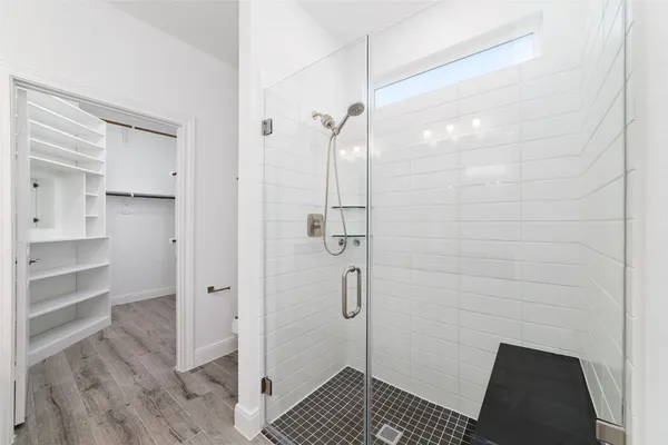a bathroom with a shower and a sink