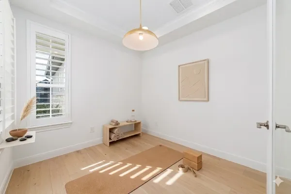 a view of a room with wooden floor and windows