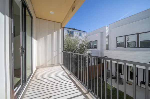 a view of a balcony with wooden floor