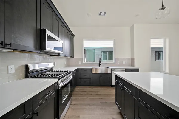 a view of a kitchen with a sink and cabinet area