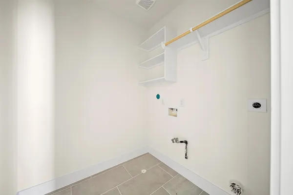 a view of empty room with wooden floor and ceiling fan