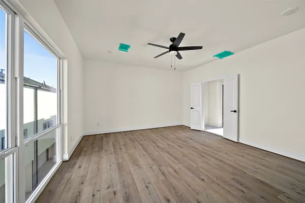 a view of a room with wooden floor and white walls