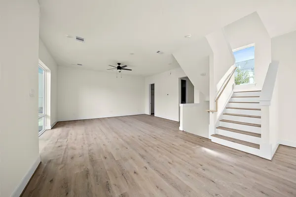 a view of a kitchen with wooden floor and electronic appliances