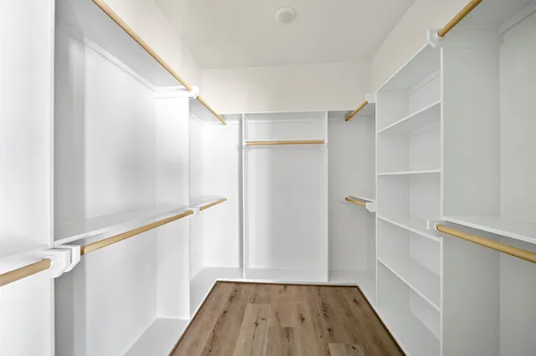 a view of hallway with wooden floor and staircase