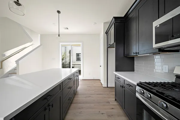 a kitchen with a sink stove and microwave