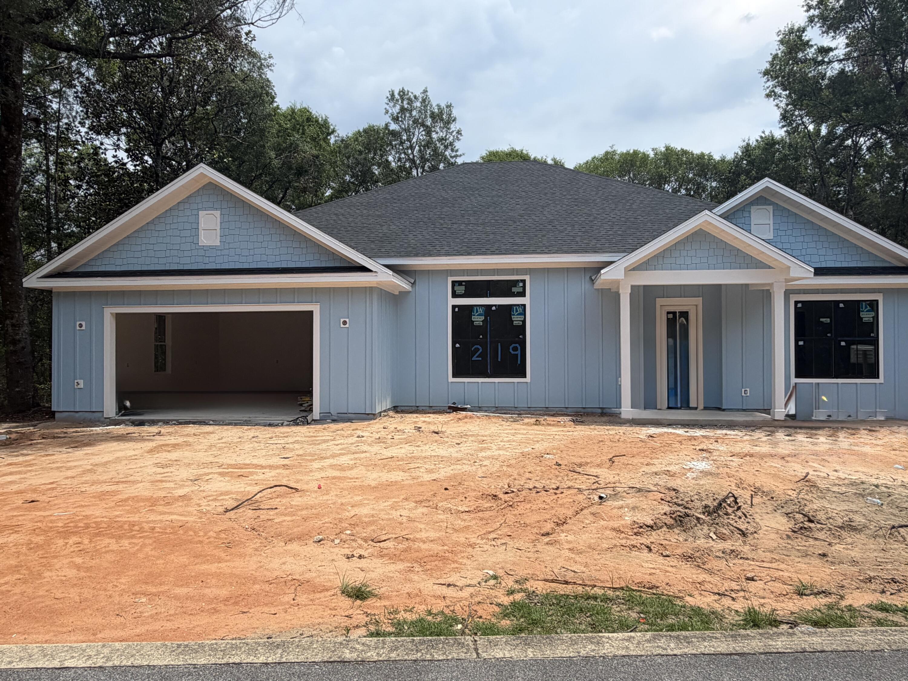 219 South J Hunter's Way, Unit LOT 73 Freeport, FL 32439 - Photo 1 of 10 a front view of a house with a yard and garage
