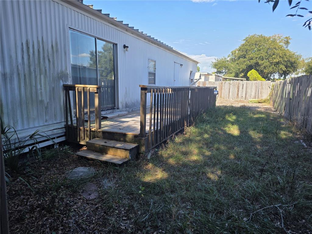 6525 Tralee Avenue New Port Richey, FL 34653 - Photo 11 of 11 a view of a backyard with wooden fence