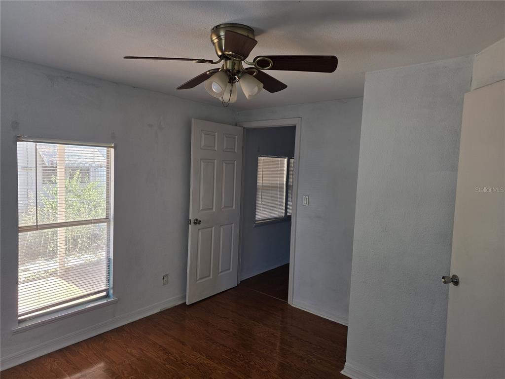 6525 Tralee Avenue New Port Richey, FL 34653 - Photo 5 of 11 a view of an empty room with wooden floor and a window
