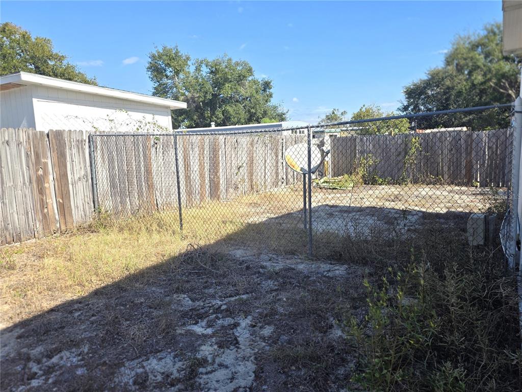 6525 Tralee Avenue New Port Richey, FL 34653 - Photo 10 of 11 a view of outdoor space with wooden fence