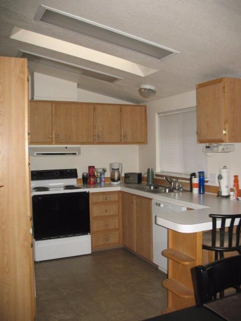 580 Raven Road Central Point, OR 97502 - Photo 10 of 17 a kitchen with stainless steel appliances granite countertop a sink stove and cabinets