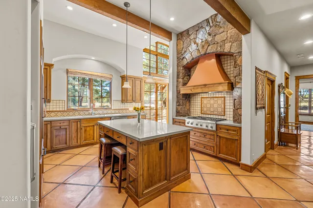 a kitchen with stainless steel appliances granite countertop a sink and a refrigerator