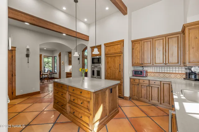 a view of backyard with kitchen island and seating space