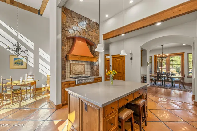 a view of a dining room with furniture a chandelier and wooden floor