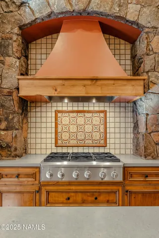 a dining room with furniture a chandelier and wooden floor