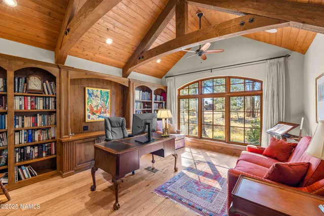 a bedroom with two beds and a chandelier
