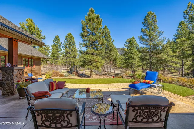 a view of yard with seating area and trees