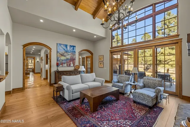 a living room with fireplace furniture and a chandelier