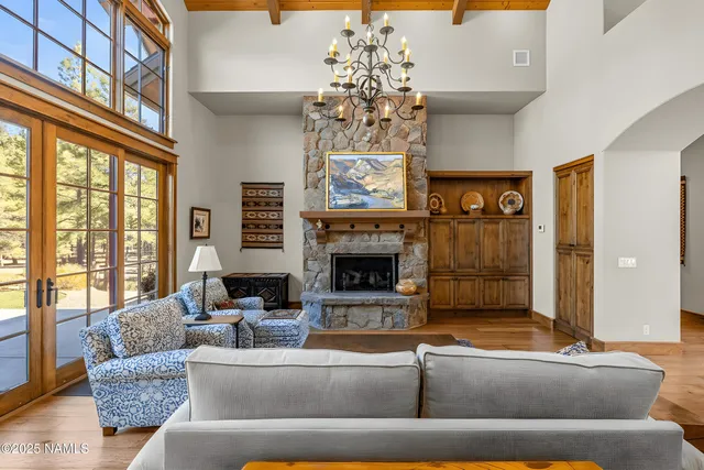 a living room with patio furniture and a chandelier