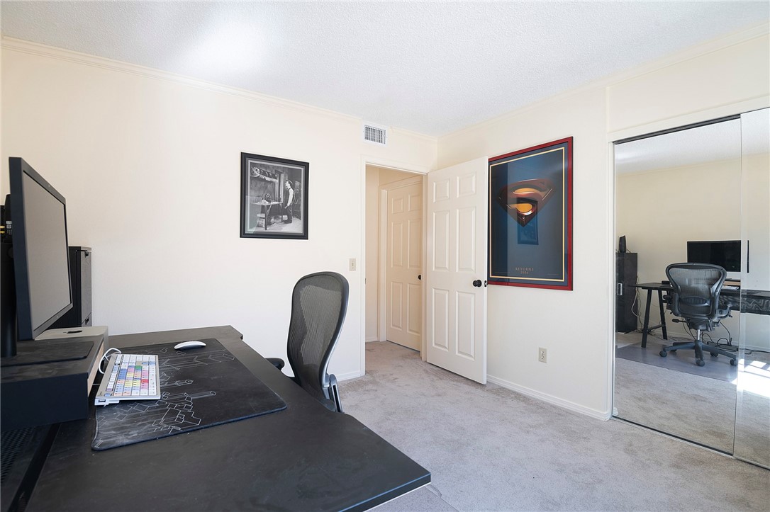 12065 Crystal Glen Way Porter Ranch, CA 91326 - Photo 26 of 38 a view of a workspace with furniture and a flat screen tv