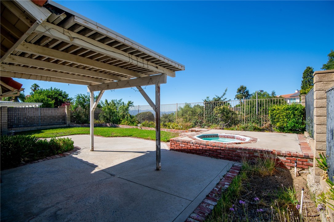12065 Crystal Glen Way Porter Ranch, CA 91326 - Photo 27 of 38 a view of a patio with a table and chairs under an umbrella