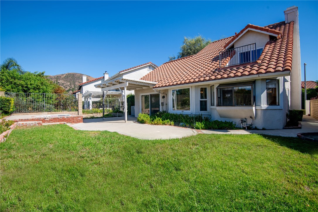 12065 Crystal Glen Way Porter Ranch, CA 91326 - Photo 29 of 38 a view of a house with a yard porch and sitting area