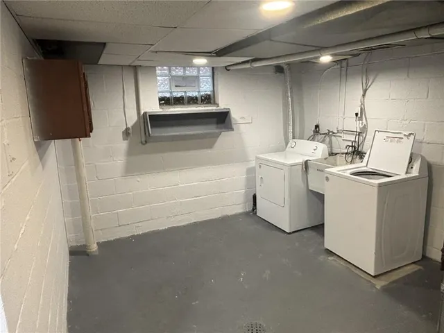 a view of storage and utility room with washer and dryer