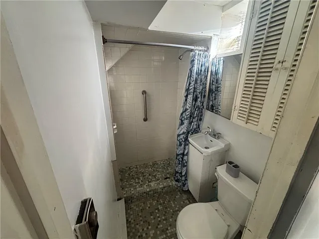 a bathroom with a toilet and shower