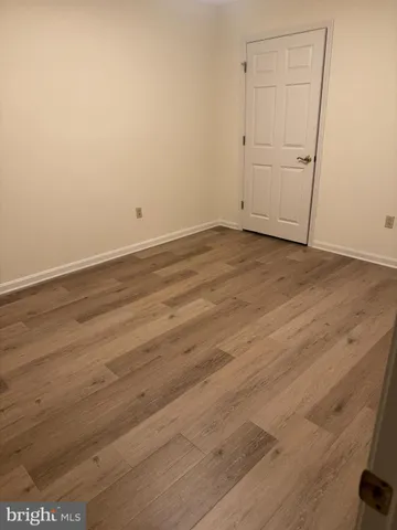 an empty room with wooden floor