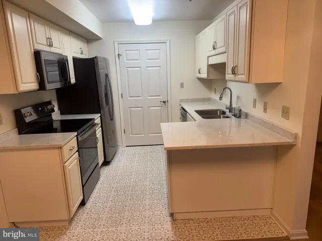 a kitchen with a sink appliances and cabinets