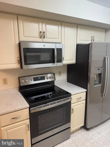 a kitchen with appliances and a microwave
