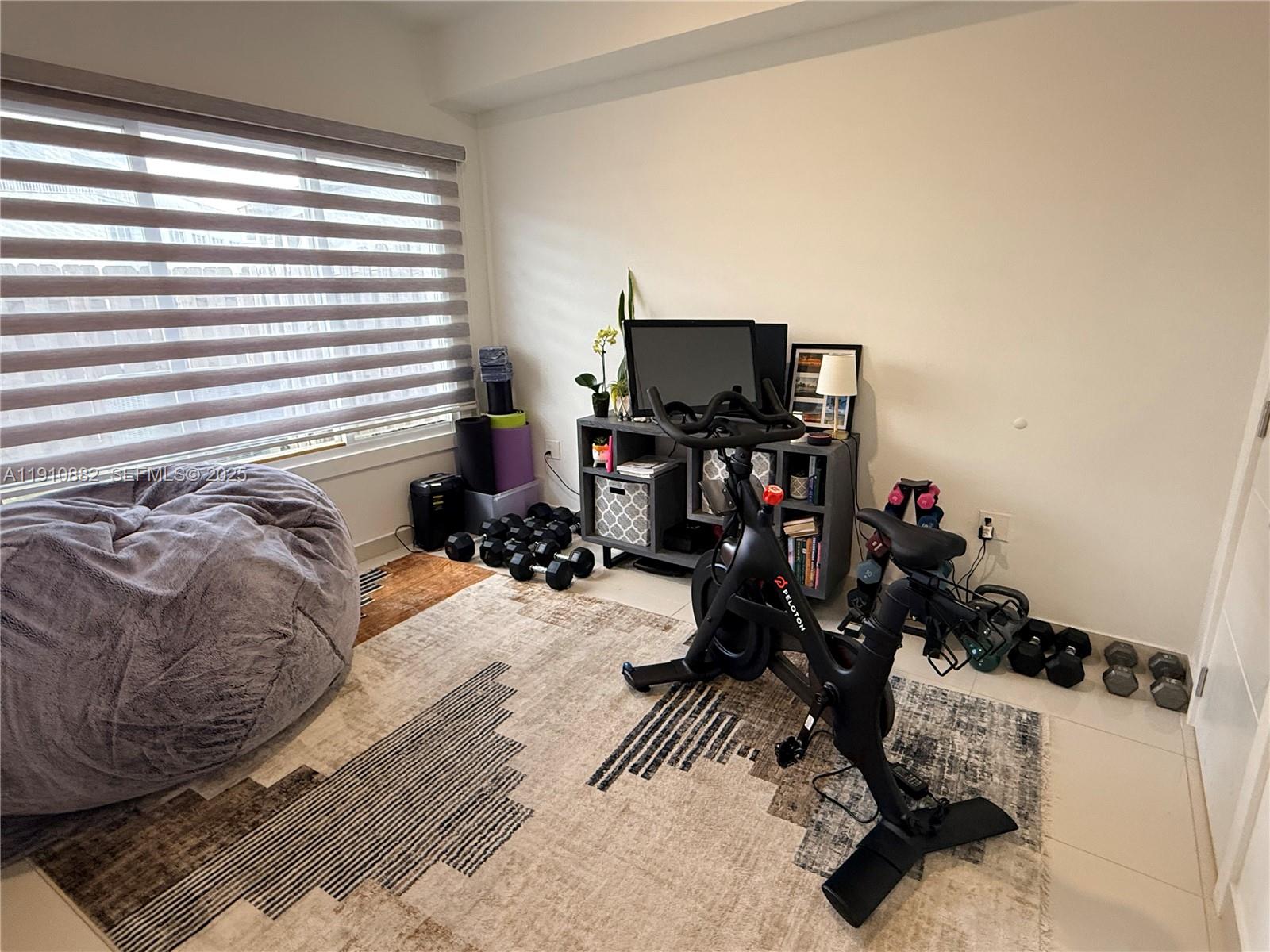 25855 Southwest 139th Court Homestead, FL 33032 - Photo 11 of 23 a bedroom with a bed and a tv