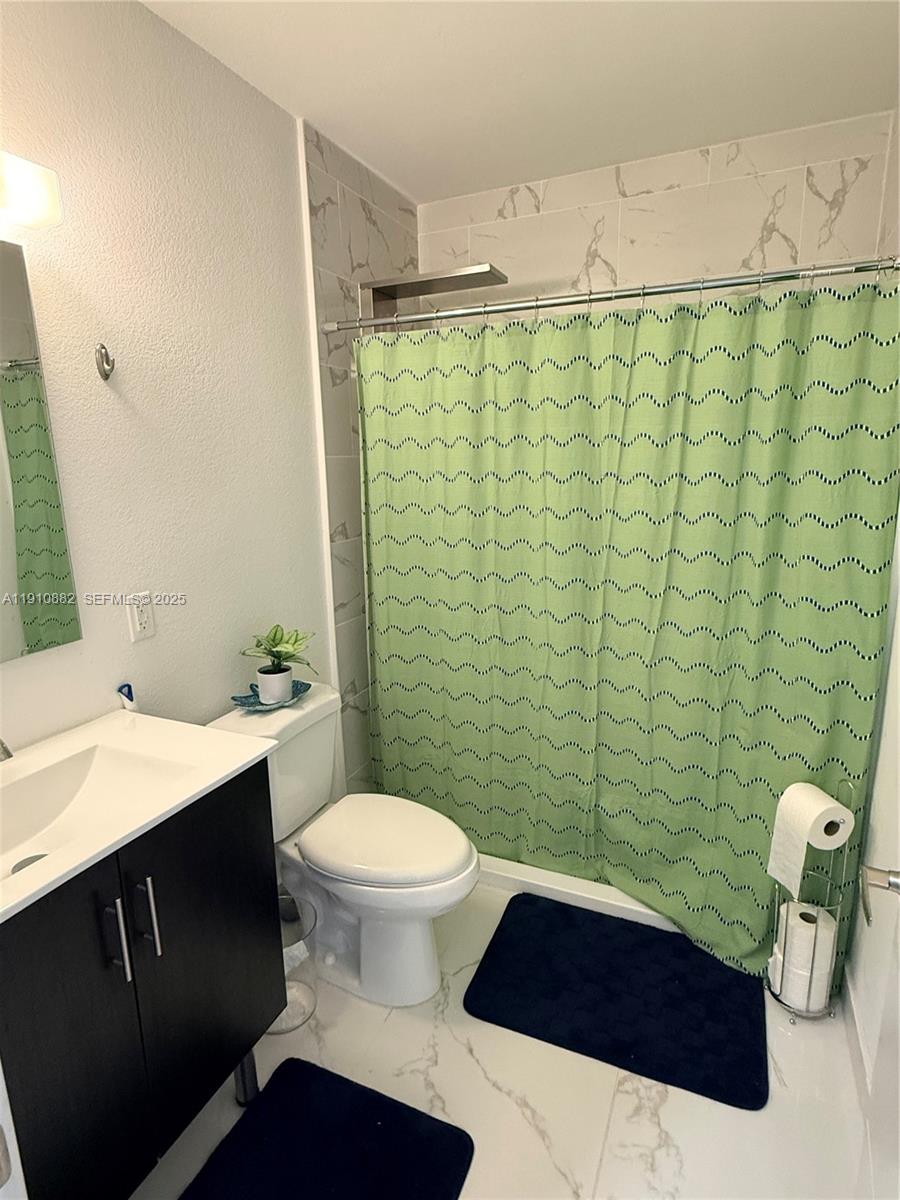 25855 Southwest 139th Court Homestead, FL 33032 - Photo 12 of 23 a bathroom with a sink and a toilet