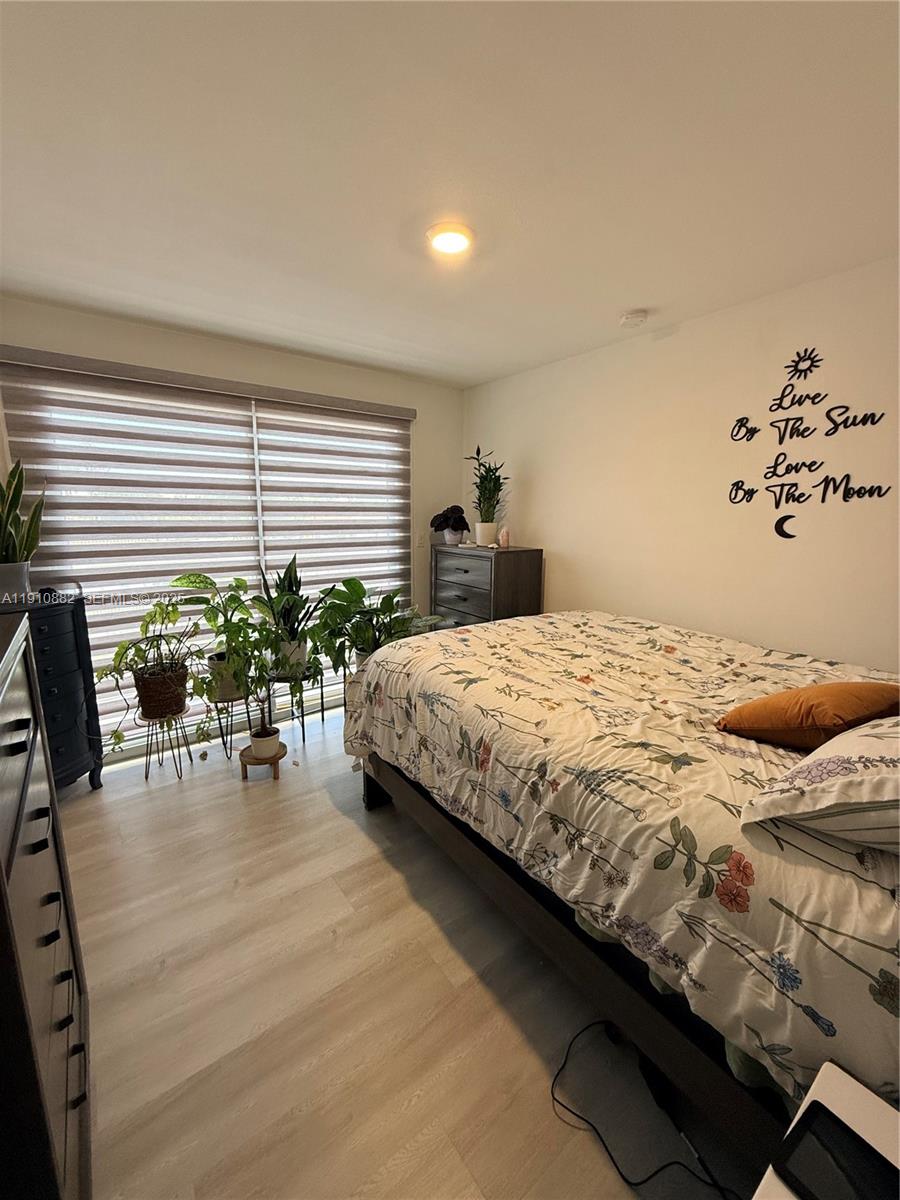 25855 Southwest 139th Court Homestead, FL 33032 - Photo 15 of 23 a bedroom with a bed table and chairs