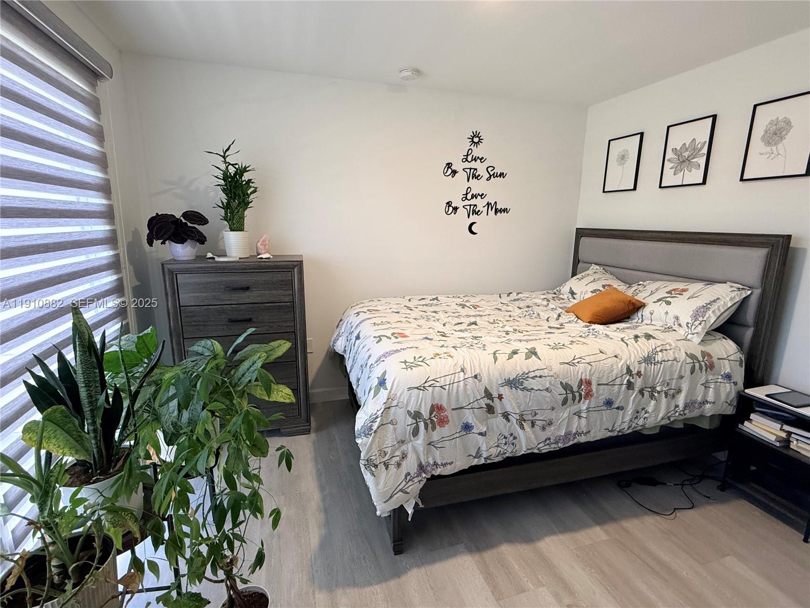 25855 Southwest 139th Court Homestead, FL 33032 - Photo 16 of 23 a bedroom with a bed and a potted plant